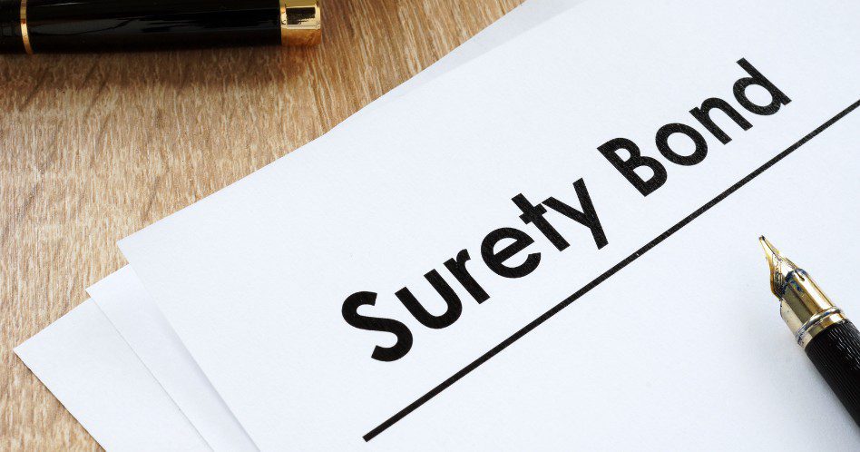 Surety bond form and pen on a table.